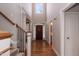 Elegant foyer with hardwood floors, staircase, and high ceilings with a large window at 4325 New Hope Springs Dr, Hillsborough, NC 27278