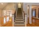 Inviting foyer showcasing a staircase with wood railing and open views to the living and dining areas at 4325 New Hope Springs Dr, Hillsborough, NC 27278