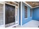 Elegant front entry with a sleek black door, wood ceiling, and ample natural light at 4325 New Hope Springs Dr, Hillsborough, NC 27278