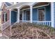 Charming covered front porch with wood ceiling and a partial view of the yard at 4325 New Hope Springs Dr, Hillsborough, NC 27278