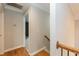 Hallway with hardwood floors and neutral paint, leading to additional rooms and stairs at 4325 New Hope Springs Dr, Hillsborough, NC 27278