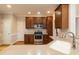 A kitchen featuring stainless steel appliances, granite countertops, and wooden cabinetry at 4325 New Hope Springs Dr, Hillsborough, NC 27278