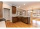 Kitchen showcases stainless appliances, wood floors, and an open layout to the living area at 4325 New Hope Springs Dr, Hillsborough, NC 27278