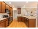 An open-concept kitchen with wood flooring, a breakfast bar, and views into the living room at 4325 New Hope Springs Dr, Hillsborough, NC 27278