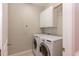Laundry room with side-by-side washer and dryer and built-in upper cabinet storage at 4325 New Hope Springs Dr, Hillsborough, NC 27278