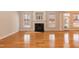 Sun-drenched living room featuring hardwood floors, a fireplace, and an abundance of natural light at 4325 New Hope Springs Dr, Hillsborough, NC 27278