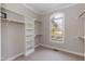 Walk-in closet with built-in shelving, hanging rods and a window for natural light at 4325 New Hope Springs Dr, Hillsborough, NC 27278