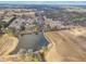 Community aerial view with pond and open land on a sunny day under a blue sky at 505 Wild Goose Ln, Creedmoor, NC 27522