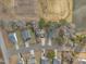 Aerial view displays houses, driveways, and surrounding landscape with a pond nearby, highlighting community layout at 505 Wild Goose Ln, Creedmoor, NC 27522