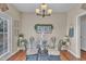 Cozy dining area featuring a modern chandelier, table setting, and natural lighting at 505 Wild Goose Ln, Creedmoor, NC 27522