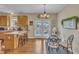 Eat-in kitchen, with breakfast bar and dining table, leads to french doors and backyard at 505 Wild Goose Ln, Creedmoor, NC 27522