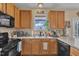 Functional kitchen space featuring modern black appliances and ample natural light at 505 Wild Goose Ln, Creedmoor, NC 27522