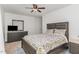 This bedroom features a floral comforter, ceiling fan, and a dark wood dresser with a mirror at 510 N Mineral Springs Rd, Durham, NC 27703