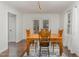 Bright dining room with a wooden table and chairs, hardwood floors, and large windows at 510 N Mineral Springs Rd, Durham, NC 27703