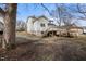 View of backyard showing the home and deck on a partly sunny day at 512 S Mebane St, Burlington, NC 27215