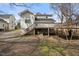 Back of the home with a wooden deck and staircase leading to the yard at 512 S Mebane St, Burlington, NC 27215