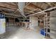 Basement with exposed beams, water heater, workbench, and concrete walls and floor at 512 S Mebane St, Burlington, NC 27215