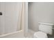 Bright bathroom showcases a shower with a curtain and a toilet at 512 S Mebane St, Burlington, NC 27215