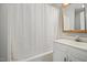 Functional bathroom with a tub, shower curtain, vanity, and ample storage at 512 S Mebane St, Burlington, NC 27215