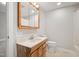 Bright bathroom features wood vanity with countertop sink, mirror and medicine cabinet at 512 S Mebane St, Burlington, NC 27215