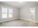 Bright bedroom featuring neutral walls, plush carpeting, and abundant natural light at 512 S Mebane St, Burlington, NC 27215