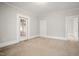 Large bedroom features neutral carpeting, and a glass paneled door at 512 S Mebane St, Burlington, NC 27215