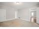 Spacious bedroom boasts neutral walls, plush carpeting, and abundant natural light at 512 S Mebane St, Burlington, NC 27215