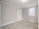 Cozy bedroom features carpet, a window, and a door at 512 S Mebane St, Burlington, NC 27215