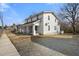 Traditional two-story home with a covered front porch and gravel driveway at 512 S Mebane St, Burlington, NC 27215