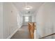 Bright hallway with natural lighting, carpet, and wooden railing staircase at 512 S Mebane St, Burlington, NC 27215