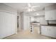 Well-lit kitchen with white cabinetry, a ceiling fan, and ample counter space for meal preparation and storage at 512 S Mebane St, Burlington, NC 27215