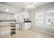 Bright kitchen with white cabinets, modern appliances, and a breakfast bar, perfect for casual dining at 512 S Mebane St, Burlington, NC 27215