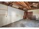 Shed interior with exposed beams, pegboard, concrete floor, and installed cabinetry at 512 S Mebane St, Burlington, NC 27215