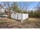Outdoor shed with double doors and weathered exterior is surrounded by grass and trees at 512 S Mebane St, Burlington, NC 27215
