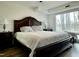 Main bedroom featuring a large bed, wood floors, a ceiling fan, and plenty of natural light at 518 Edwin Ct, Roxboro, NC 27573