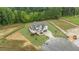An aerial shot of a two-story home with a well-manicured lawn and surrounding woods at 5705 Flowery Meadow Ct, Wake Forest, NC 27587