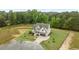 Aerial view of a modern two-story home with lush green lawn and wooded surroundings at 5705 Flowery Meadow Ct, Wake Forest, NC 27587