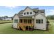 A house back exterior features a wooden deck, stairs and nice yard at 5705 Flowery Meadow Ct, Wake Forest, NC 27587