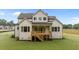 Rear exterior featuring a wooden deck, large windows and pristine lawn, perfect for outdoor enjoyment at 5705 Flowery Meadow Ct, Wake Forest, NC 27587