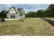 View of backyard featuring lush green lawn and wooded lot line at 5705 Flowery Meadow Ct, Wake Forest, NC 27587