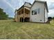 View of backyard with a wooden deck, steps, grassy lawn, and the home's rear elevation at 5705 Flowery Meadow Ct, Wake Forest, NC 27587