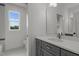 New bathroom with marble floors, gray vanity, and white countertop with a view from the window at 5705 Flowery Meadow Ct, Wake Forest, NC 27587