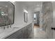 Bright bathroom with a double vanity and marble accents in the shower at 5705 Flowery Meadow Ct, Wake Forest, NC 27587