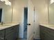 New bathroom featuring double vanity, spacious mirror, and modern fixtures at 5705 Flowery Meadow Ct, Wake Forest, NC 27587