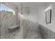 Luxurious bathroom featuring a marble-tiled walk-in shower with a bench and a modern vanity at 5705 Flowery Meadow Ct, Wake Forest, NC 27587