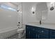 Stylish bathroom with navy blue vanity, white countertops, and modern fixtures at 5705 Flowery Meadow Ct, Wake Forest, NC 27587