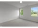 Bright bedroom with carpeted floor and multiple windows offering outdoor views at 5705 Flowery Meadow Ct, Wake Forest, NC 27587