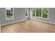 Empty bedroom with large windows offering beautiful backyard views at 5705 Flowery Meadow Ct, Wake Forest, NC 27587