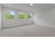 Well lit bedroom with neutral carpet, white walls, base molding and 3 large windows at 5705 Flowery Meadow Ct, Wake Forest, NC 27587