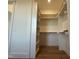 Bright walk-in closet with custom shelves and hardwood floors at 5705 Flowery Meadow Ct, Wake Forest, NC 27587